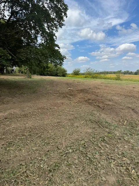 Open lot after land clearing beside a field in central Illinois by Foil Land Services